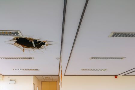 gypsum ceiling decay hole interior office buildingの写真素材