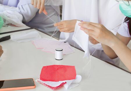 people making homemade mask fabric prevent coronavirus or (Covid-2019)  in community city. concept prophylaxisの写真素材