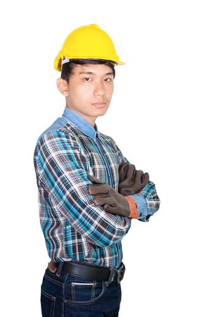 Engineering construction arm cross on chest  and wear Leather gloves with yellow safety helmet plastic isolated on white backgroundの写真素材