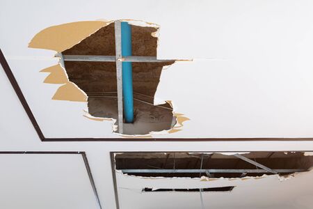 repair leak water pipe in under gypsum ceiling interior office building