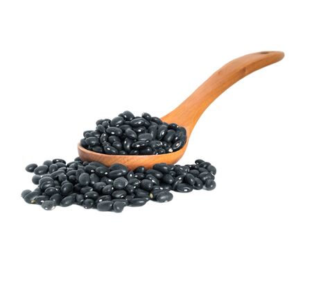black beans with wooden spoon on white backgroundの写真素材