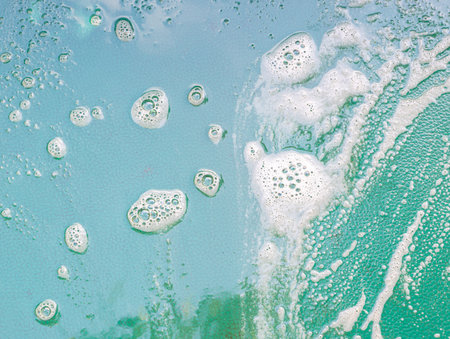 shampoo foam surface bubbles cleansing on green backgroundの写真素材