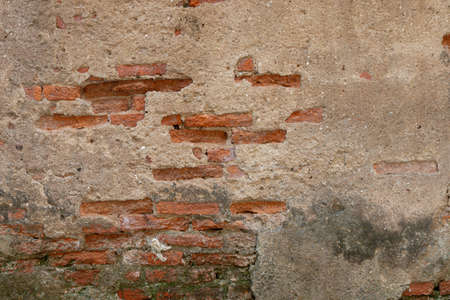 red brick block wall texture old background ancient weathered brick wall with cracks and destroyed stucco layer with copy spaceの写真素材