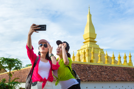 Selfie, Two girlfriends traveling to Wat Phra That Luang in vientiane,Laosの写真素材