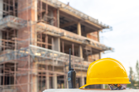 Radio and helmet in construction site and construction site worker background safety first conceptの写真素材