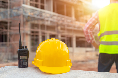 Radio and helmet in construction site and construction site worker background safety first conceptの写真素材