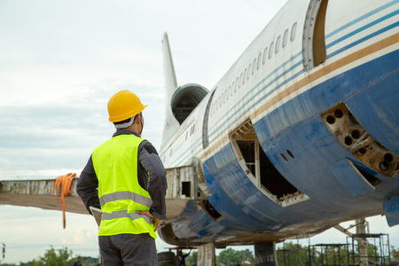 Engineer looking at Old airplane for maintenance an airplane are performing repairs, fixes, modernization and renovation.の写真素材