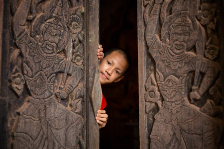 The novice monk opens the door to the idea of opening the mind to learn the world wide.の写真素材
