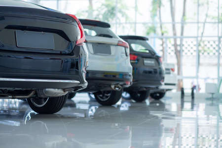 Cars For Sale. Automotive Industry. Cars Dealership Parking Lot. Rows of Brand New Vehicles Awaiting New Owners in the showroom.の写真素材