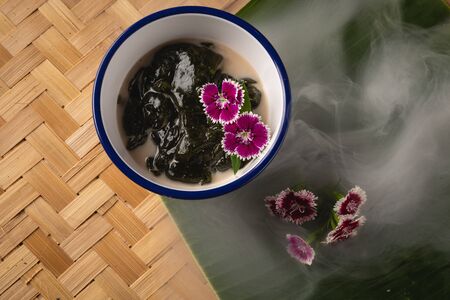 Thai dessert, Icevine, Pareira barva with coconut milk on wooden table, Top viewの写真素材