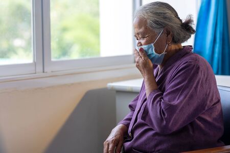 Senior asian woman wearing face mask during corona virus and flu outbreak. Disease and illness protection. the aging female patient that is at risk for infection corona virus [covid-19].の写真素材