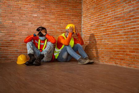 Asian people Construction work shutdown due to outbreak of Coronavirus Disease 2019 or COVID-19. Concept of economic crisis, worker construction unemployment.の写真素材