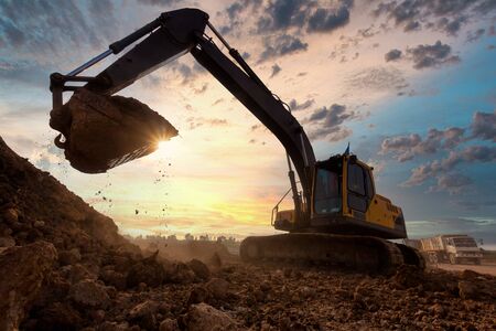 excavator at sandpit during earthmoving works in the construction site.の写真素材