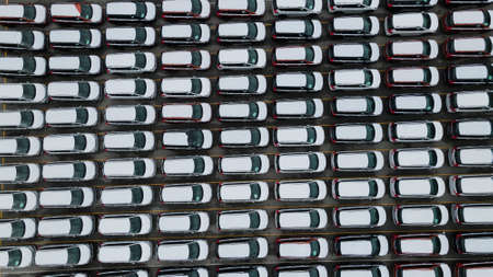 Aerial view new car lined up in the port for import and export business logistic to dealership for sale, Automobile and automotive car parking lot for commercial business car industry.の写真素材