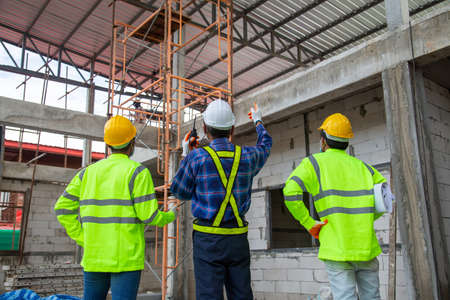 Asian engineer technician team inspector of workers to productivity build a house in the construction siteの写真素材