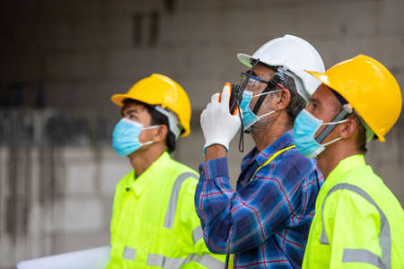 Close-up Asian engineer technician team inspector of workers to productivity build a house in the construction site to control the quality of workの写真素材