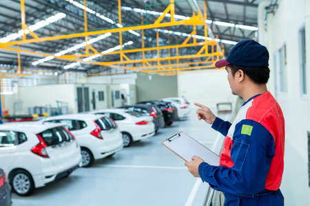Asian man car inspector staff checking stock in the car service centerの写真素材