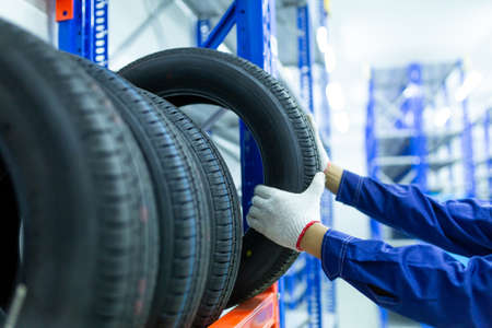 New tires that change tires in the auto repair service center in the stock blur for the industry, a four-wheeled tire set at a warehouseの写真素材