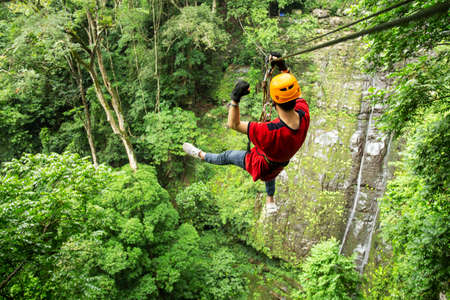 Freedom adult Man Tourist Wearing Casual Clothing On Zip Line Or Canopy Experienceの写真素材