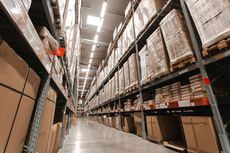 Warehouse interior with shelves, pallets and boxes, Rows of shelves with goods boxes in modern industry warehouse store at factory warehouse storage.の写真素材