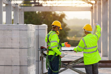 Asian engineers and workers consulted together for construction planning and development, Concept of construction team work.の写真素材