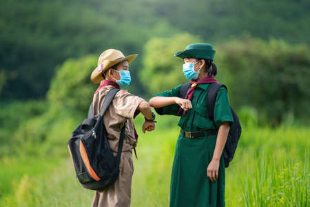 Asian Scout  wearing a mask and Show a new normal greetingの写真素材