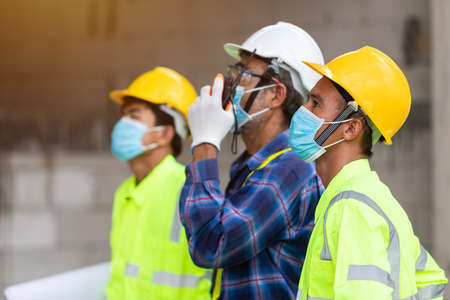 Close up team construction worker control in the House structure at construction siteの写真素材