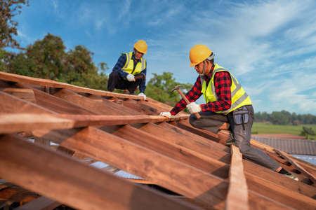 Roofer, Two roofer carpenter working on roof structure on construction site, Teamwork construction concept.の写真素材