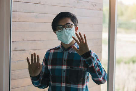 freelance man detain from society wear protective masks and unemployment at home Concept of economic crisis, people unemployment and production of Coronavirus Disease 2019 or COVID-19.の写真素材