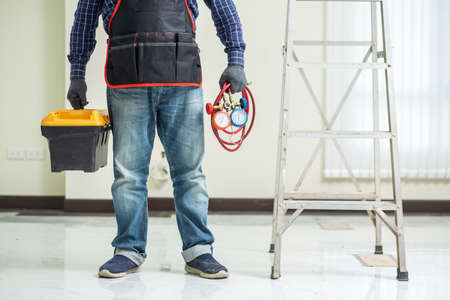 Air conditioner technician with toolbox and tools, Repair of air-conditioner conceptの写真素材