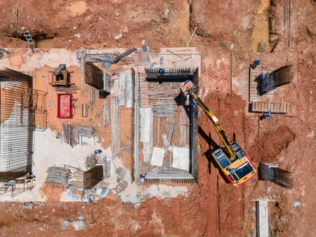 aerial view or Top View Busy worker at construction site with excavator working at Construction Site and heavy construction machine Construction Equipmentの写真素材