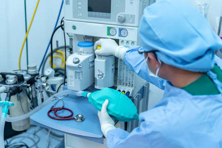 assistant working heart rate surgeon's team in uniform performs an operation on a patient at a cardiac surgery clinic. Modern medicine, a professional team of surgeons, health.の写真素材