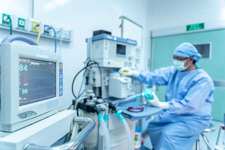 Selective focus of monitor, assistant working heart rate monitor surgeon's team in uniform performs an operation on a patient at a cardiac surgery, Life-saving devices in surgery, Surgical equipmentの写真素材