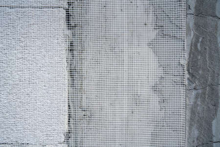 Putty wall reinforced with mesh or plastering mesh, equipment  of wall insulation. Construction...