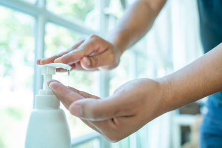 Close up cleaning hands with sanitizer gel, Wash your hands with alcohol gel.の写真素材