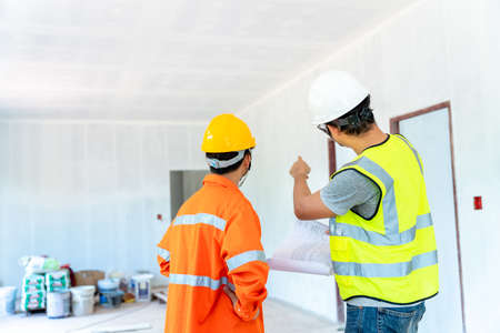 architect and engineer with foreman inspect housing estate building to success construction plan before send quality housing to customers at the construction siteの写真素材