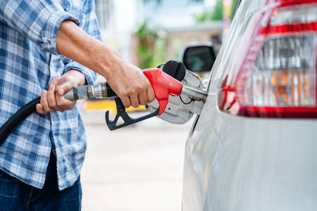 close-up hand of refuel the car by yourself, Pumping equipment gas at gas station.の写真素材