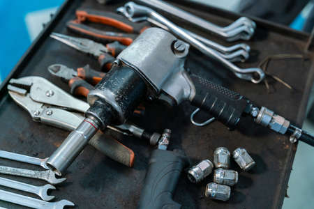 equipment of car mechanic adjusting tension in vehicle suspension Element at auto repair service center, car suspension conceptの写真素材