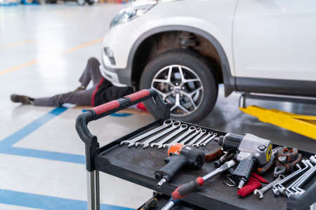 select focus equipment of car mechanic adjusting tension in vehicle suspension Element at auto repair service center, car suspension conceptの写真素材