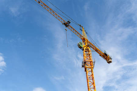 close up  of Industrial construction cranes and building on blue sky heavy machine construction siteの写真素材