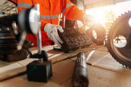 Close up hand of A mechanic man Small Excavator Repair and Maintenance. Heavy Equipment Mechanic Trying to Find an Issue. Industrial Theme.の写真素材