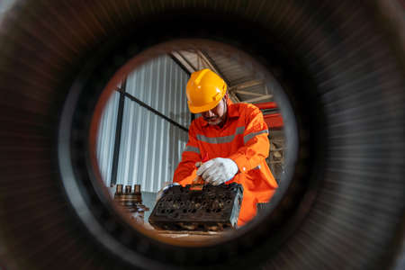 An excavator repair technician working inspection and repair maintenance heavy machinery, Industrial Theme.の写真素材