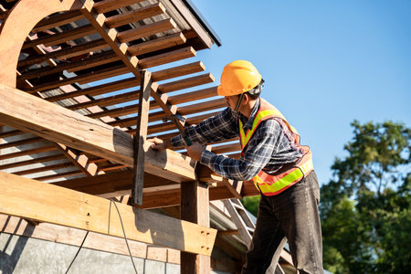 Roofer, A carpenter working on roof structure on construction siteの写真素材