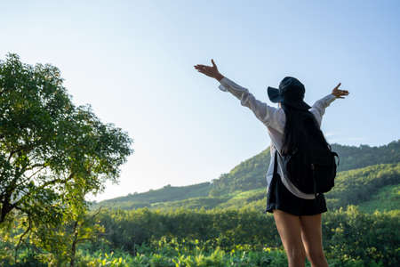 A young woman enjoying freedom with open hands on mountain.の写真素材