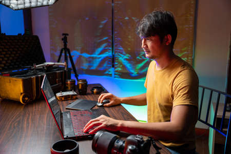A man makes video editing. Video production. Color Correction. Sound editing. Film making. The work...