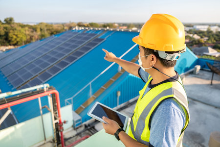 An engineer checking the operation of the system Solar power on the roof, Photovoltaic module idea for clean energy production. solar panel on roof.の写真素材