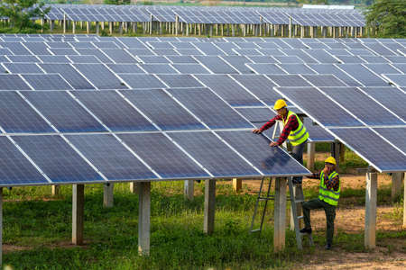 Asian team electrician installing solar panels working on alternative energy sources clean, Solar Power.の写真素材