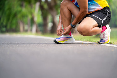 Close up of Senior Man tying running shoes.の写真素材