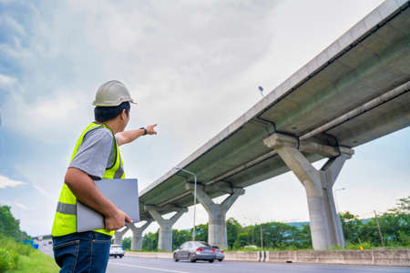 Civil Engineer Architecture holding laptop inspection project road construction development.の写真素材