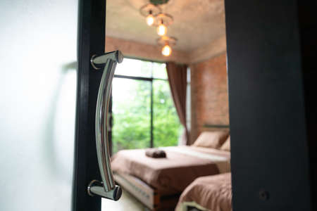 Vintage style brown bedroom in hotel, select focus door.の写真素材